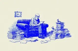 An elderly man sitting and reading a book