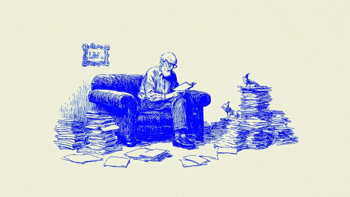 An elderly man sitting and reading a book